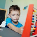 schoolboy-learning-maths-with-an-abacus-2021-08-26-20-15-04-utc